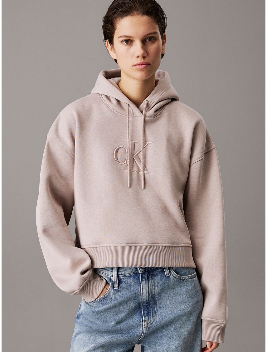 Buzo beige holgao con capota y monograma